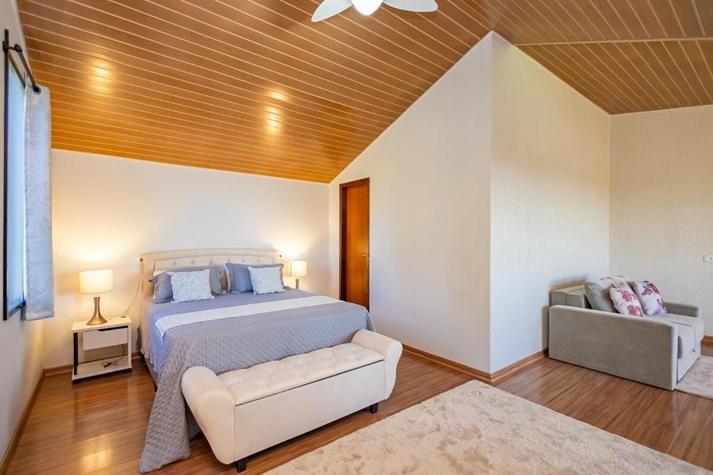 Suíte com cama de casal e sofá